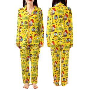 May include: A yellow long-sleeve pajama set with a button-down top and matching pants. The fabric features a repeating pattern of Toy Story characters, red hats, blue balls, and the text "TS" and "I KNEW IT, I KNEW YOU" in a colorful graphic print.