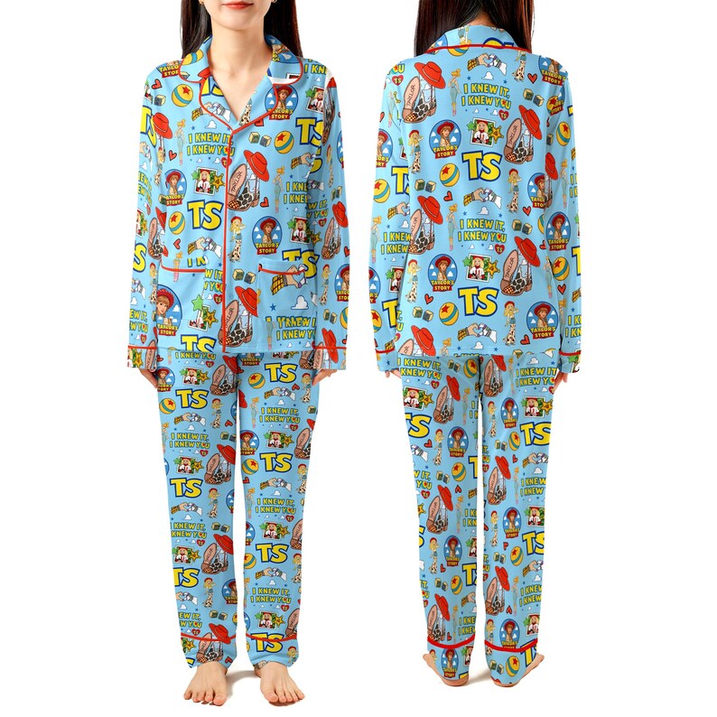 May include: A light blue pajama set featuring a repeating pattern of Toy Story characters, red hats, yellow balls, and the text TS and I KNEW IT I KNEW YOU. The long-sleeved button-down top has red piping, and the matching long pants have an elastic waistband.