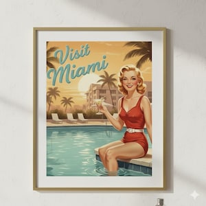 May include: A framed vintage travel poster with the text "Visit Miami." The artwork depicts a woman in a red swimsuit holding a cocktail, sitting by a pool. Palm trees and a sunset are in the background, evoking a retro vacation vibe.