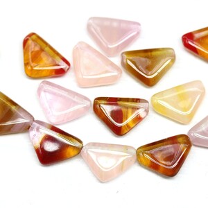 May include: Assortment of triangular shaped glass beads in pink, yellow, and orange with red and gold swirls.