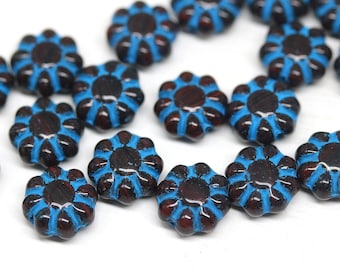 May include: A collection of blue and brown glass flower-shaped beads. The beads have a raised design and are perfect for jewelry making.