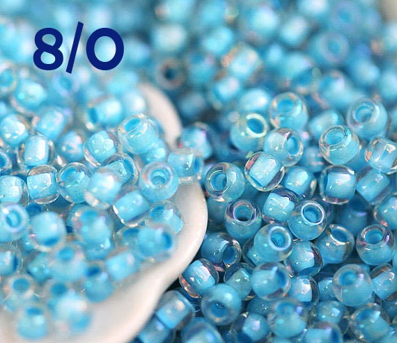 15//0 Round TOHO Japan Glass Seed Beads #288-Crystal//Metallic Blue Lined 10 grams