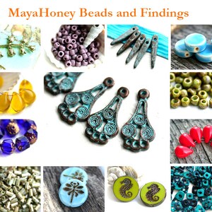 May include: Assortment of colorful glass and ceramic beads and findings for jewelry making.  Includes turquoise, green, blue, red, yellow, and purple beads.  Also includes metal findings with a turquoise patina.