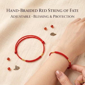 May include: A hand-braided red string bracelet featuring gold-toned accents and an adjustable design. The text reads: Hand-Braided Red String of Fate, Adjustable, Blessing & Protection. Includes small red beads and bronze-coloured cloud charms.