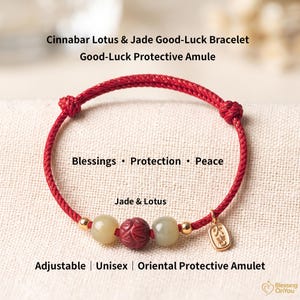 May include: An adjustable bracelet featuring a red cord, two pale green jade beads, and a central red cinnabar bead carved with a lotus pattern. It includes small gold-toned metal beads and a rectangular gold-toned charm with Chinese characters.