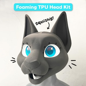 May include: A dark gray Foaming TPU Head Kit featuring a stylized animal mask with large, bright blue eyes, pointed ears, and an open mouth. The text "Foaming TPU Head Kit" and "squishy!" with an arrow are visible on the image.