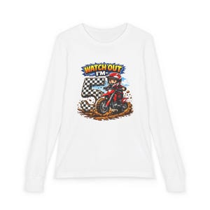 May include: White long-sleeve shirt featuring a colorful graphic of a child riding a red dirt bike. The graphic includes the text "WATCH OUT I'M 5" with a checkered flag and mud splash details. The shirt is designed for a child's birthday.