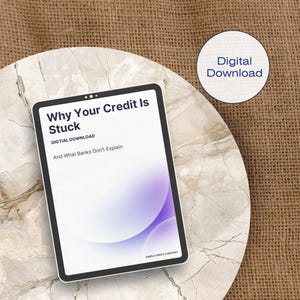 May include: A digital download titled "Why Your Credit Is Stuck" on a tablet. The screen displays the title, the words "DIGTIAL DOWNLOAD", and "And What Banks Don't Explain". A circular graphic reads "Digital Download". The tablet is on a marble surface.