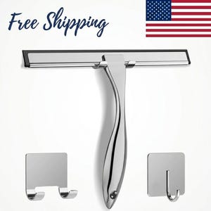 May include: A chrome-finished shower squeegee with a black rubber blade, a curved handle, and two matching adhesive hooks. The words "Free Shipping" are in the upper left corner. An American flag is in the upper right corner.