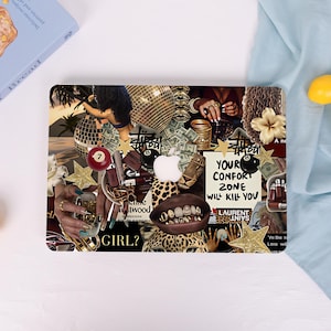 May include: A laptop skin featuring a collage of images including a disco ball, stacks of cash, billiard balls, gold teeth, leopard print, and a white Apple logo. The text reads YOUR CONFORT ZONE WILL KILL YOU, STUSSY, and GIRL.