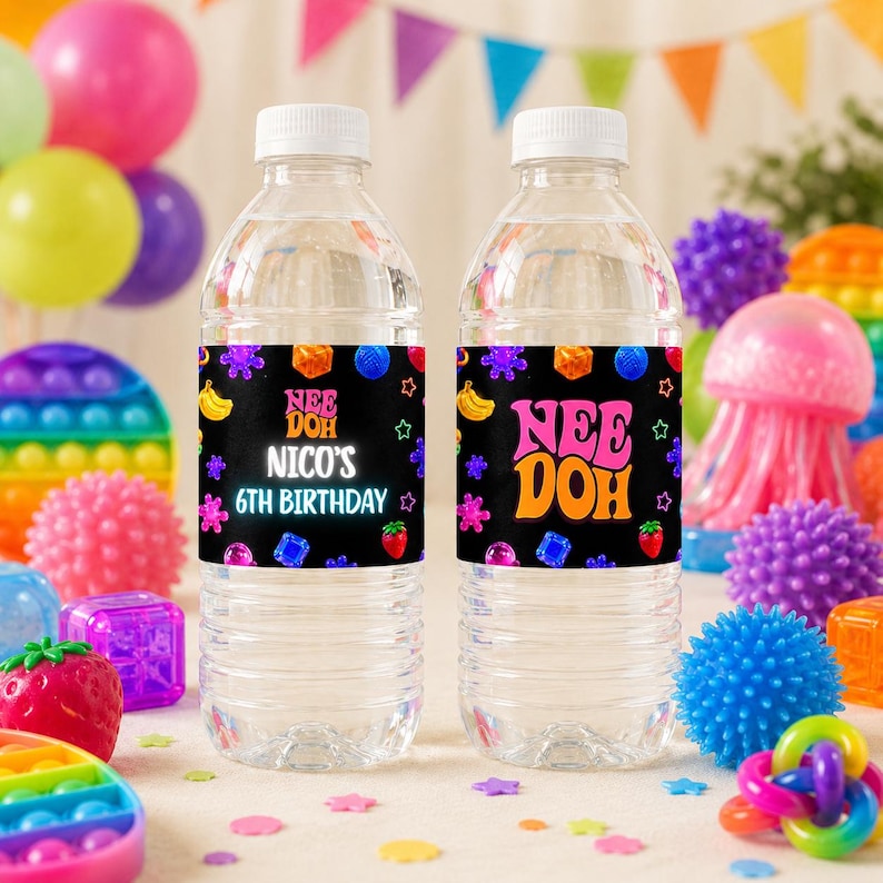 May include: Two clear plastic water bottles with black labels featuring colorful graphics of fruit, gems, and stars. The left label reads "NEE DOH NICO'S 6TH BIRTHDAY" in white and pink text, while the right label reads "NEE DOH" in large pink and orange letters.