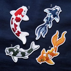 May include: Four embroidered koi fish patches labeled 1 through 4. Patch 1 is white and red, patch 2 is white and dark blue, patch 3 is white and dark green, and patch 4 is white and orange. Each patch features a detailed fish design.