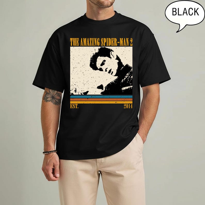May include: Black t-shirt with a vintage graphic from "The Amazing Spider-Man 2". The design includes a sepia-toned image of a person, the film title, and the year 2014. The word "BLACK" is in a speech bubble.