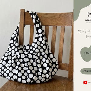 May include: A black and white polka dot pleated handbag rests on a wooden chair. The bag has a rounded shape and a wide strap. The image includes text that says "Pleated Handbag Sewing", "One Size", and "Beginner Friendly".