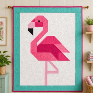 May include: A rectangular wall quilt featuring a geometric flamingo design in shades of pink and magenta on a white background. The quilt is framed by a wide teal border and a thin magenta binding, showcasing a quilted texture throughout the fabric.