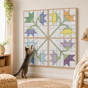 May include: A wall hanging quilt composed of four square panels. Each panel features a star-shaped floral design in shades of green, blue, yellow, and purple. The quilt is bordered with a natural-colored fabric and is mounted on a white wall.