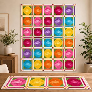 May include: A rectangular quilt and a matching table runner featuring a repeating geometric rose pattern. The design consists of multi-colored fabric blocks in shades of yellow, orange, pink, purple, and blue, separated by green borders and white grid lines.