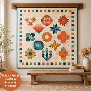 May include: A square wall quilt featuring thirteen distinct floral and geometric blocks in shades of coral, teal, and mustard yellow on a cream background with a quilted feather pattern and a border of alternating colored squares.