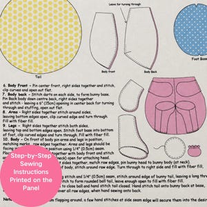 May include: A fabric sewing panel featuring printed pattern pieces for a stuffed animal, including a yellow polka dot tail, blue polka dot foot base, and pink body sections. The panel includes step-by-step sewing instructions with a 6 inch opening.