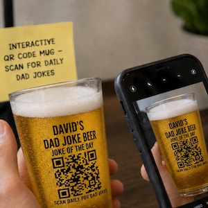 May include: A clear glass beer pint filled with golden beer, featuring black text that reads DAVID'S DAD JOKE BEER JOKE OF THE DAY, a QR code, and the text SCAN DAILY FOR DAD JOKES. A smartphone screen displays the same glass and text.