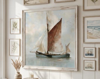 May include: A large square framed wall art piece featuring a painting of a sailboat with white and rust-colored sails on calm water. The sailboat has a dark hull and is set against a soft, muted sky. The frame is a light, distressed wood.