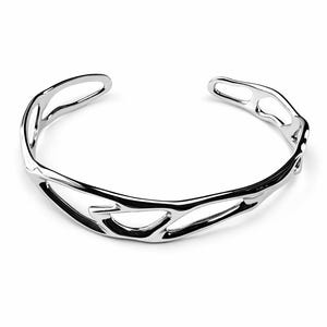 May include: A polished silver cuff bracelet with an open design. The bracelet has an organic, flowing pattern with negative space, creating a modern and elegant aesthetic. The bracelet is designed to be worn on the wrist.