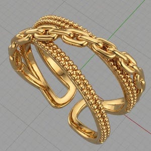 Puede incluir: Un anillo dorado con diseño de cadena. El anillo presenta una doble banda, una con textura de cuentas y otra con diseño de eslabones de cadena. El anillo es abierto en la parte inferior, lo que permite un ajuste regulable.