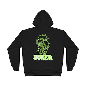 May include: Black hoodie with a neon green graphic of a jester juggling money. The word "JOKER" is displayed in neon green block letters below the jester illustration. The hoodie has a hood and long sleeves.