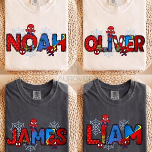 May include: Four t-shirts with the names "NOAH", "OLIVER", "JAMES", and "LIAM" printed in red, blue, and yellow, with a Spider-Man theme. The shirts are either cream or charcoal gray, with a spiderweb design.