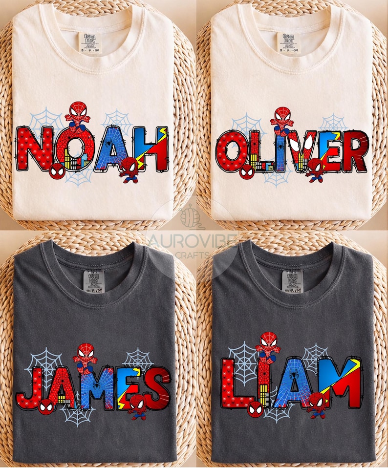 May include: Four t-shirts with the names "NOAH", "OLIVER", "JAMES", and "LIAM" printed in red, blue, and yellow, with a Spider-Man theme. The shirts are either cream or charcoal gray, with a spiderweb design.