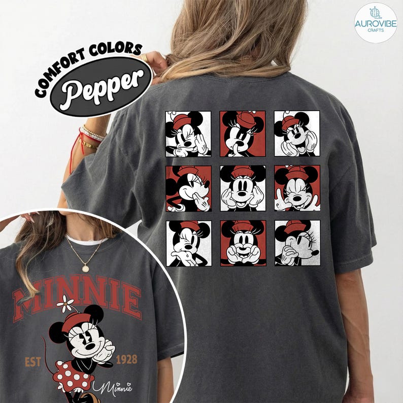 May include: Dark gray t-shirt featuring a grid of Minnie Mouse images with red and white accents. The shirt also has a front graphic with the word "MINNIE" in red, along with the text "EST 1928" and "Minnie".