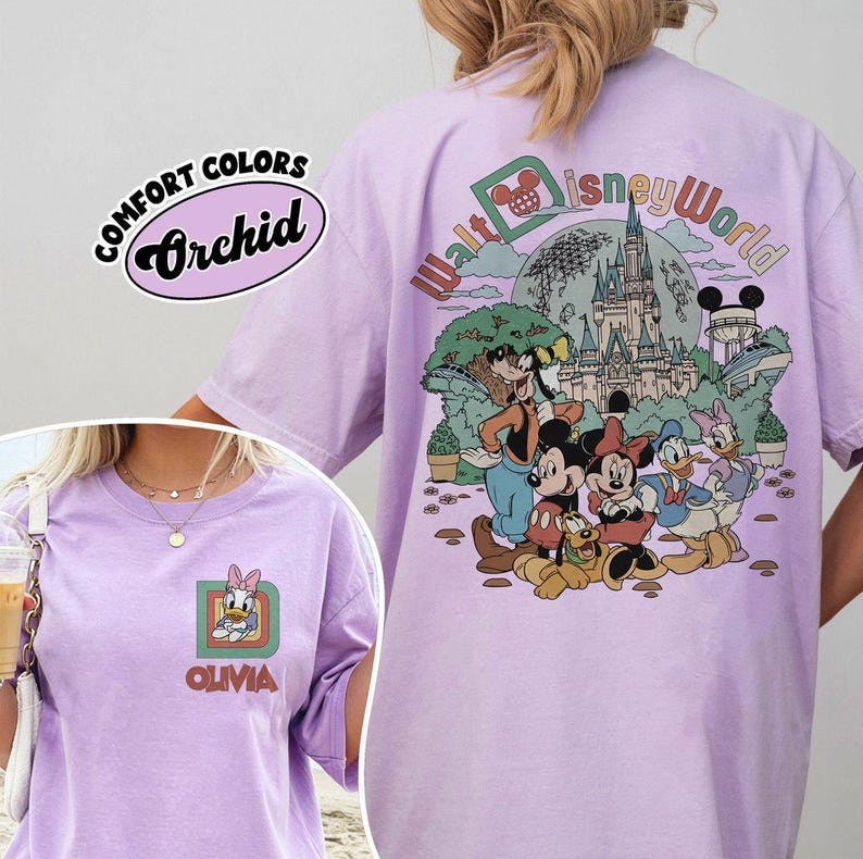 May include: Orchid-colored t-shirt with a Disney World graphic. The front features a Daisy Duck design with the name "Olivia." The back displays Disney characters and the words "Walt Disney World." The shirt is labeled "Comfort Colors."