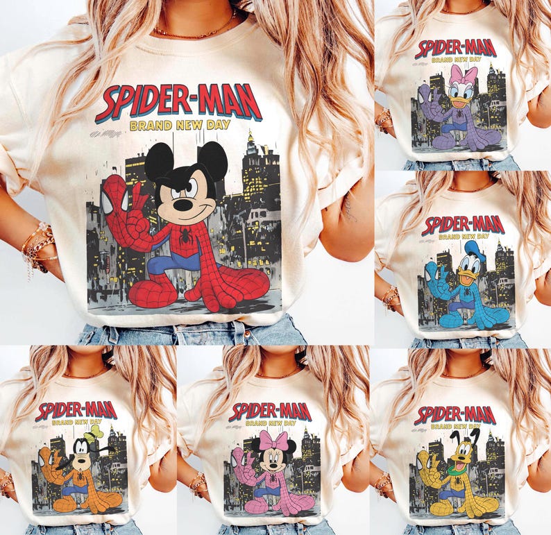 May include: Cream-colored t-shirts featuring various Disney characters in Spider-Man costumes. Each shirt has the words "SPIDER-MAN BRAND NEW DAY" printed above the character image. Characters include Mickey Mouse, Daisy Duck, Donald Duck, Goofy, and Minnie Mouse.