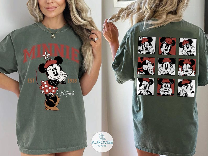 May include: Olive green t-shirt featuring a Minnie Mouse graphic. The front design includes the word "MINNIE" in red, the character, and the text "EST 1928". The back of the shirt displays nine Minnie Mouse portraits in red and white squares.