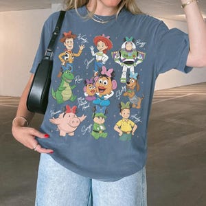 May include: A handmade wooden sign with the text "Welcome" in a playful font. The sign is painted white with a distressed finish, and features a decorative floral design in shades of pink and green. It is designed for indoor or outdoor use.