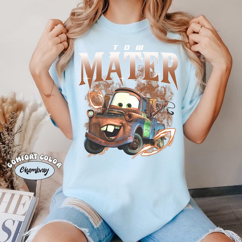 May include: A white ceramic mug with a black handle and the text "But First, Coffee" in a bold, black font. The mug is set against a neutral background, highlighting its simple design.