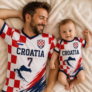 May include: A matching set consisting of an adult V-neck t-shirt and an infant bodysuit, both featuring a red and white checkered pattern, the text CROATIA, a blue map silhouette, and the Croatian national soccer crest with the number 7 on the shirt.