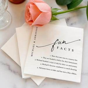 May include: A white ceramic mug with a black handle and the text "But First, Coffee" in a bold, black font. The mug is sitting on a wooden surface. The mug appears to be 12 ounces.