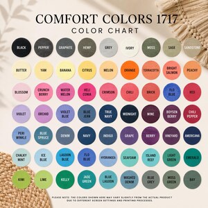 May include: A color chart titled "COMFORT COLORS 1717" displays a variety of fabric colors in circular swatches. Colors include black, grey, orange, blue, green, and more. The chart is for reference, with a disclaimer about color variations.