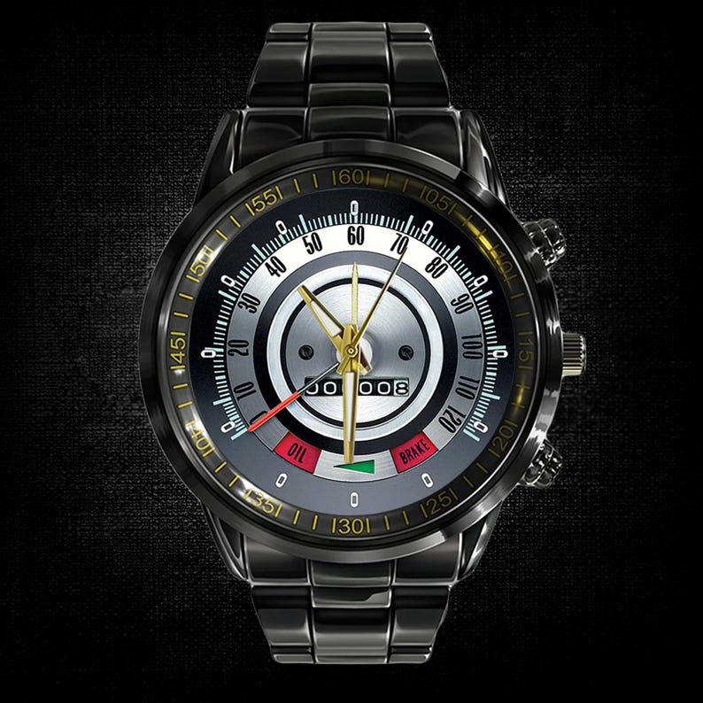 May include: Black wristwatch with a speedometer-style face. The watch features a black metal band and a dial with white, silver, and gold accents. The face includes gauges for oil and brake, and a digital display.