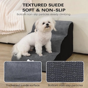 May include: A gray pet step with a textured suede surface and non-slip bottom. The step is designed to help pets climb. The text on the image reads "TEXTURED SUEDE SOFT & NON-SLIP". A small white dog is sitting on the step.