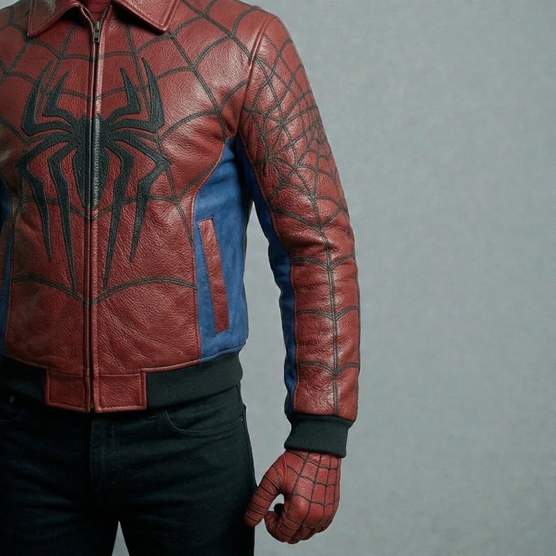 May include: Red and blue leather jacket with black spiderweb and spider design. The jacket has a zipper closure, blue side panels, and black cuffs. The design is inspired by a superhero.