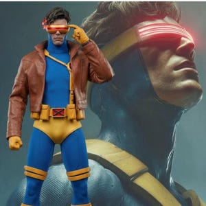 Puede incluir: Una figura de acción coleccionable de un personaje con chaqueta de cuero marrón sobre un traje azul con detalles amarillos, cinturón con emblema X rojo, guantes amarillos y una visera roja brillante sobre los ojos, con un retrato grande.