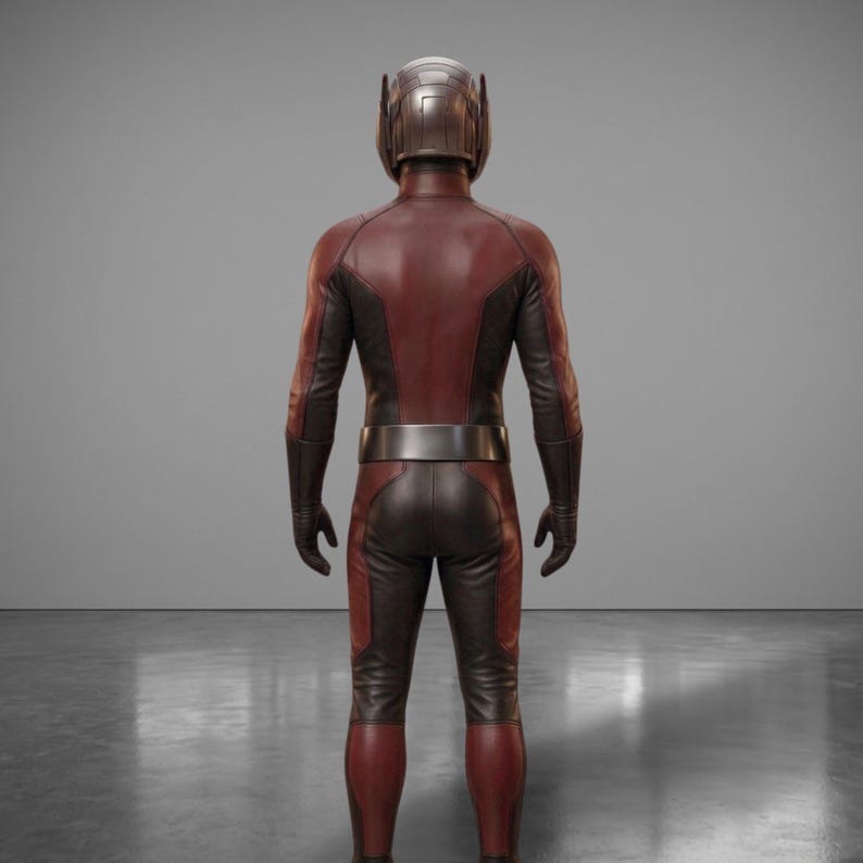 May include: A full-body costume with a helmet, gloves, and boots. The suit is primarily maroon with black accents on the arms and legs. A silver belt wraps around the waist. The helmet is metallic.
