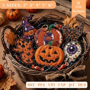 May include: A collection of embroidered Halloween-themed keychains featuring a witch hat, pumpkins, a ghost, a black cat, and an eyeball design. The items are displayed in a woven basket with text indicating 5 sizes from 2 to 6 inches.