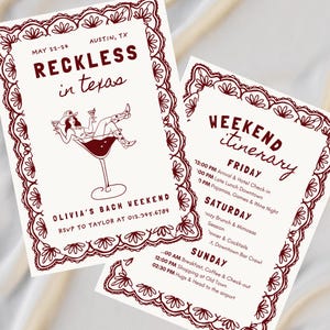 May include: Two cream-colored invitation cards with burgundy text and decorative borders. The first card reads "RECKLESS in texas" with a graphic of a woman in a cocktail glass. The second card lists a weekend itinerary. The cards are for Olivia's Bach Weekend.