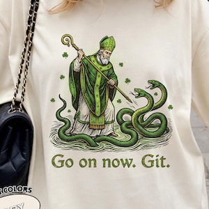 Puede incluir: Una taza de cerámica blanca con un asa negra y el texto "But First, Coffee" en negrita negra. La taza está sobre un fondo borroso. La taza mide aproximadamente 10 cm de altura.