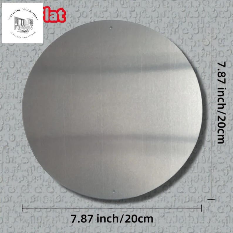 May include: A circular, silver-toned metal sign, 20 cm in diameter, with a brushed finish. The word "flat" is in red letters at the top. The sign has two small holes for hanging. The sign is from "Art Home Decoration, Limitless Creations."