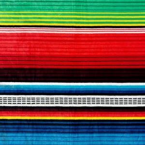 May include: A colorful textile with horizontal stripes in shades of red, green, yellow, blue, and white. The design features a repeating pattern of varying widths, creating a vibrant and textured appearance. The textile is likely a blanket or a rug.