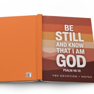 May include: An open journal with an orange cover and a colorful interior page. The interior page features the words "BE STILL AND KNOW THAT I AM GOD" in white, with the text "PSALM 46:10" and "VBS DEVOTION + NOTES" below.